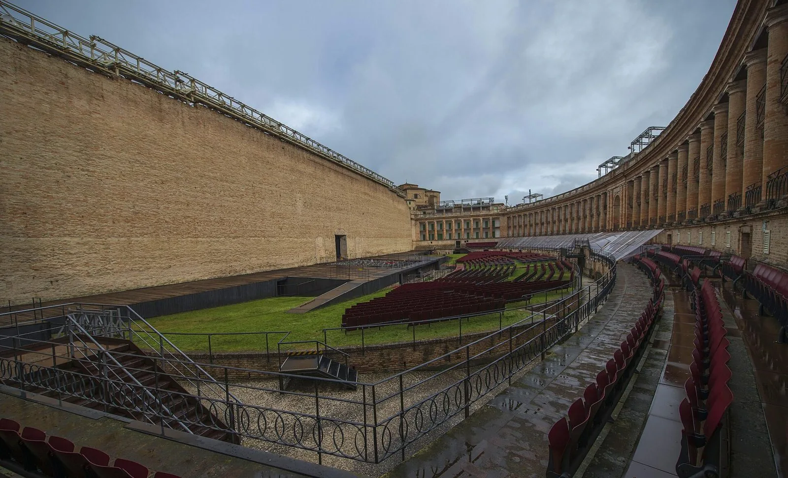 Interno dello Sferisterio di Macerata con il lungo muro di fondo, il palco e le file di poltrone